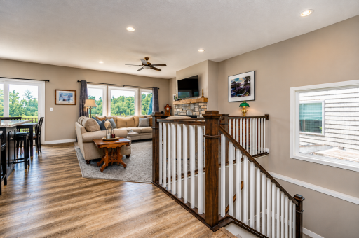 Living Room with Staircase. *Photos have been virtually staged to showcase decor