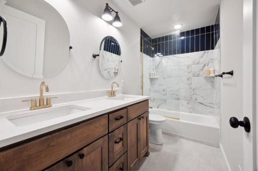 Upper shared bath - quartz counters, tile bath, glass enclosure counter /tile bath