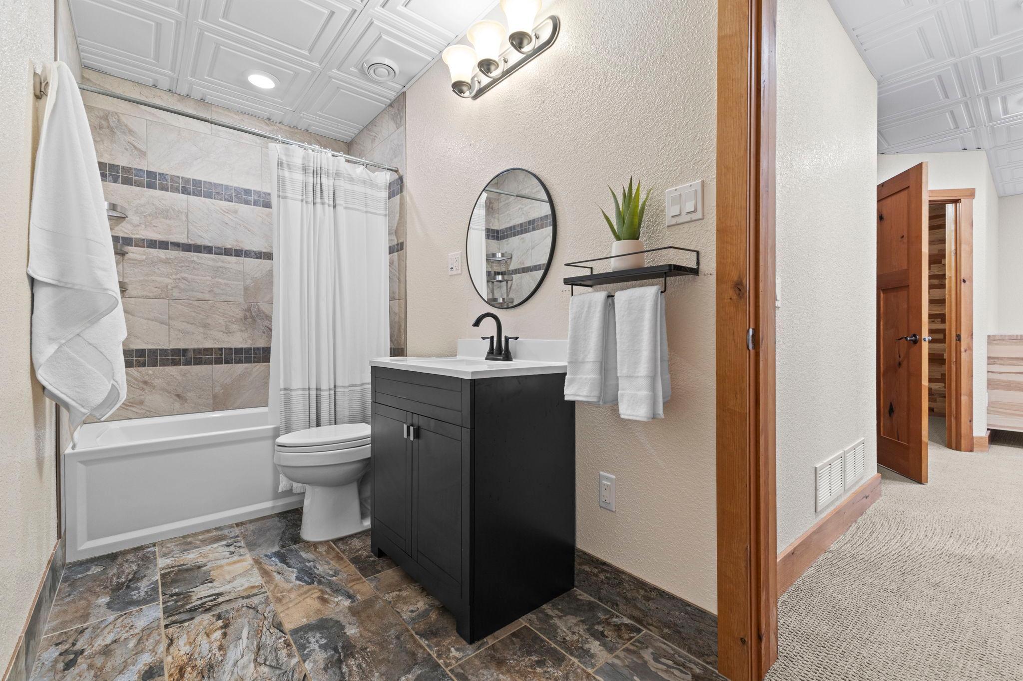 Lower-level includes a full-bath with heated tile floor.