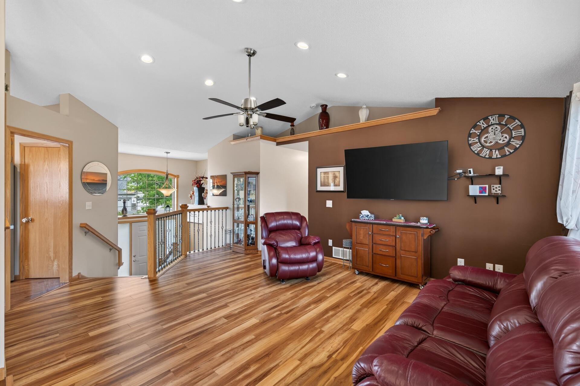 Gather in the bright and inviting living room. Vaulted ceilings and abundant natural light create the perfect place to relax with family and friends.