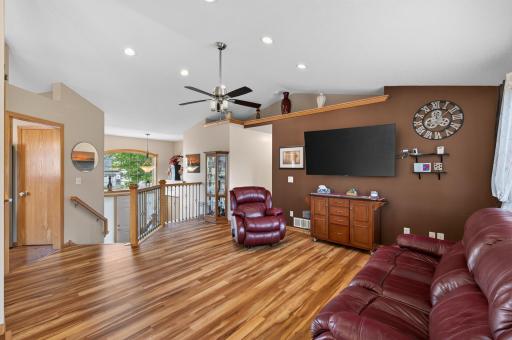 Gather in the bright and inviting living room. Vaulted ceilings and abundant natural light create the perfect place to relax with family and friends.