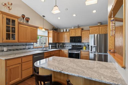 Ample cabinetry, generous counter space, and a center island make meal prep a breeze.