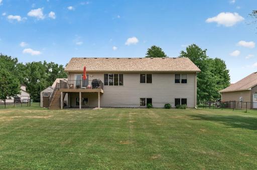 The rear elevation showcases the home's generous lot and elevated deck.