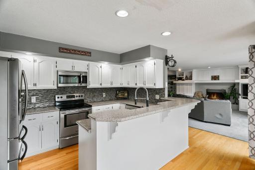 Kitchen with Water Views Virtually Staged with Grey Counter tops and Backsplash
