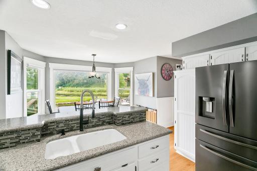 Kitchen with Water Views Virtually Staged with Grey Countertops and Backsplash