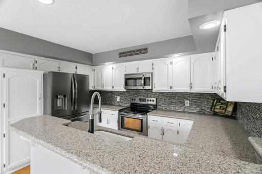 Kitchen with Water Views Virtually Staged with Grey Countertops and Backsplash
