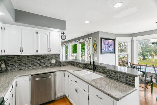 Kitchen with Water Views Virtually Staged with Grey Countertops and Backsplash