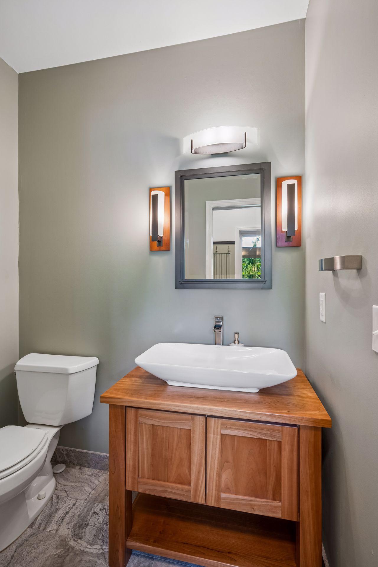 Main floor half bath, located off of the garage and laundry area