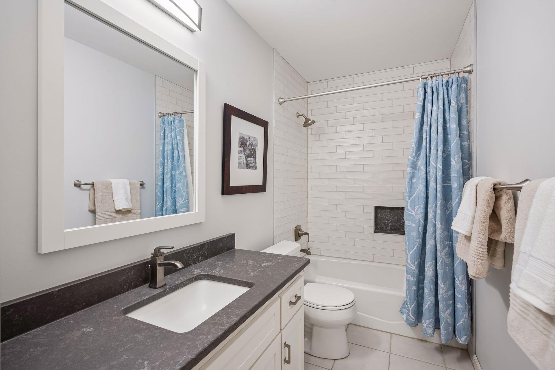Separate full bathroom on the upper level, with tiled shower with inset