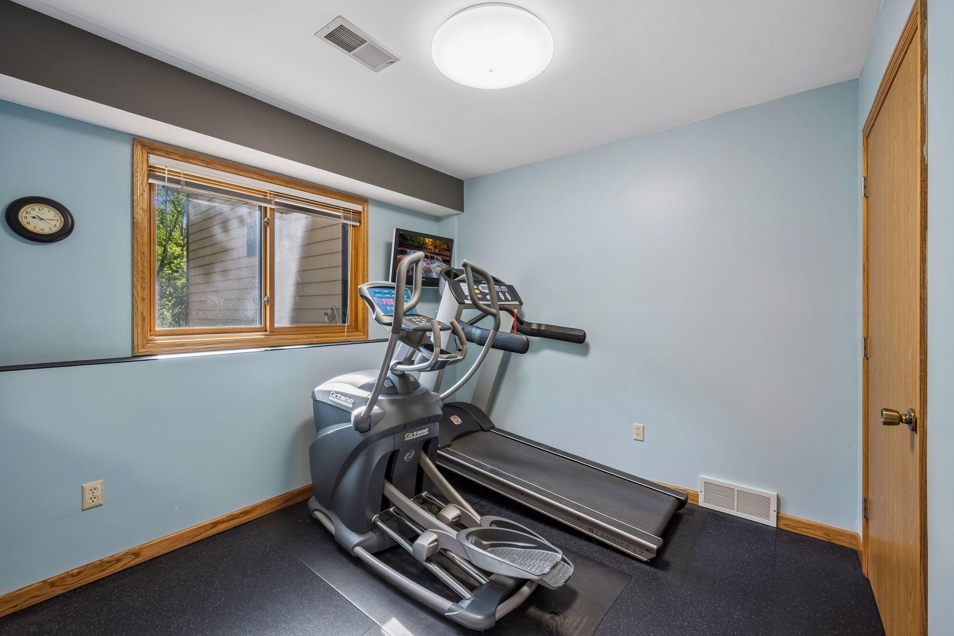 Bedroom 4 on the lower level, currently utilized as a workout room