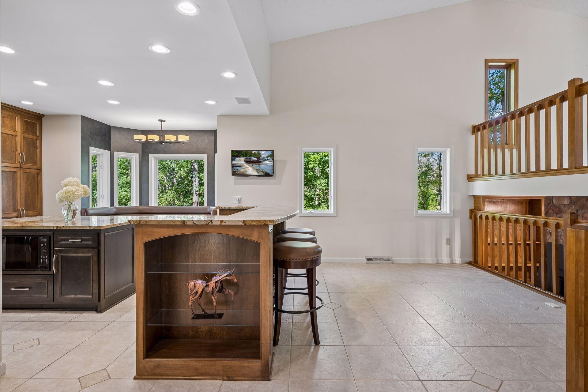 An expansive gourmet kitchen is connected to the dining area