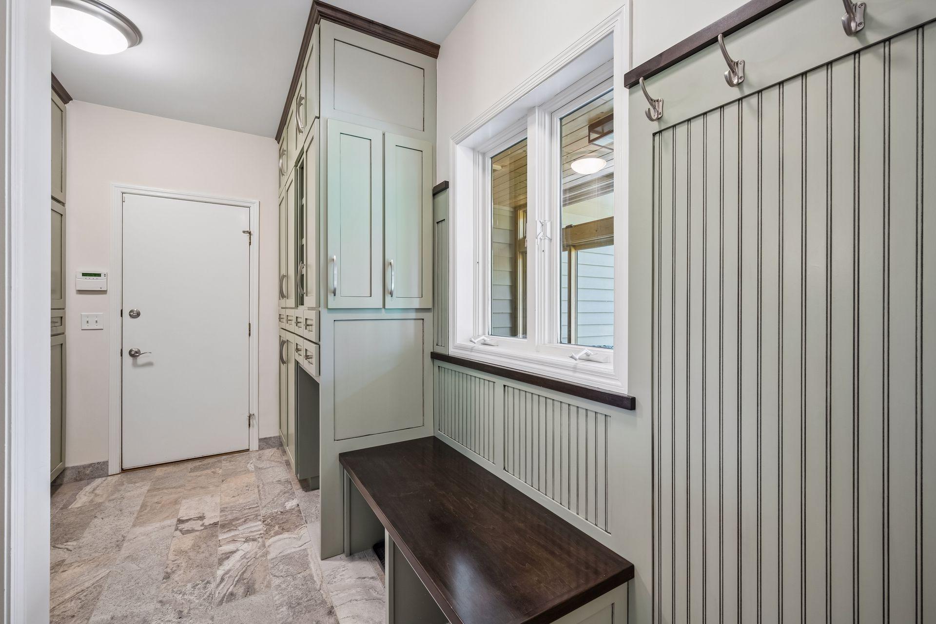Off the garage entry is the main floor laundry and mud room, complete with thoughtful custom cabinetry for functional storage