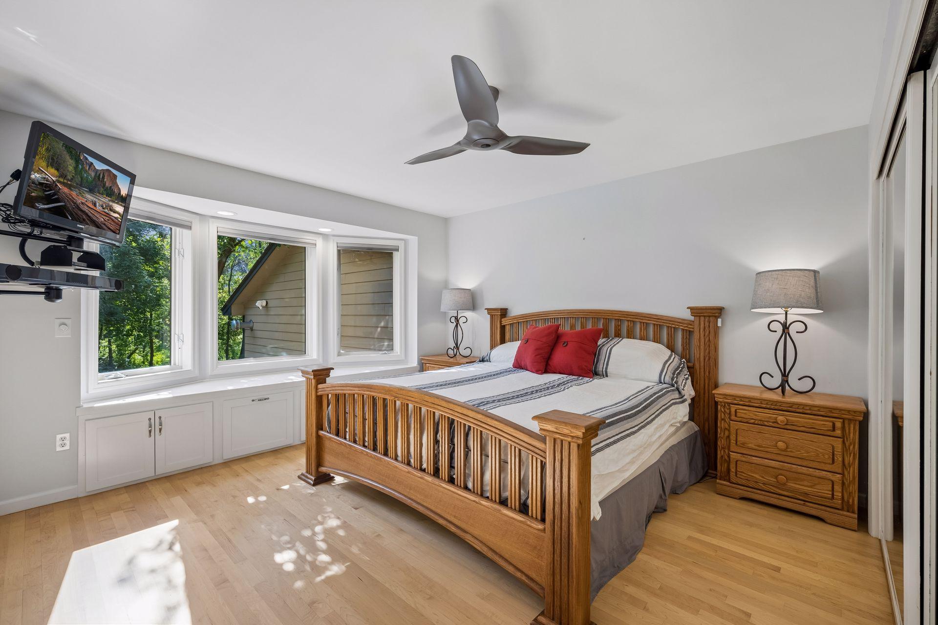 An expansive primary retreat, with maple hardwood flooring and large bay window