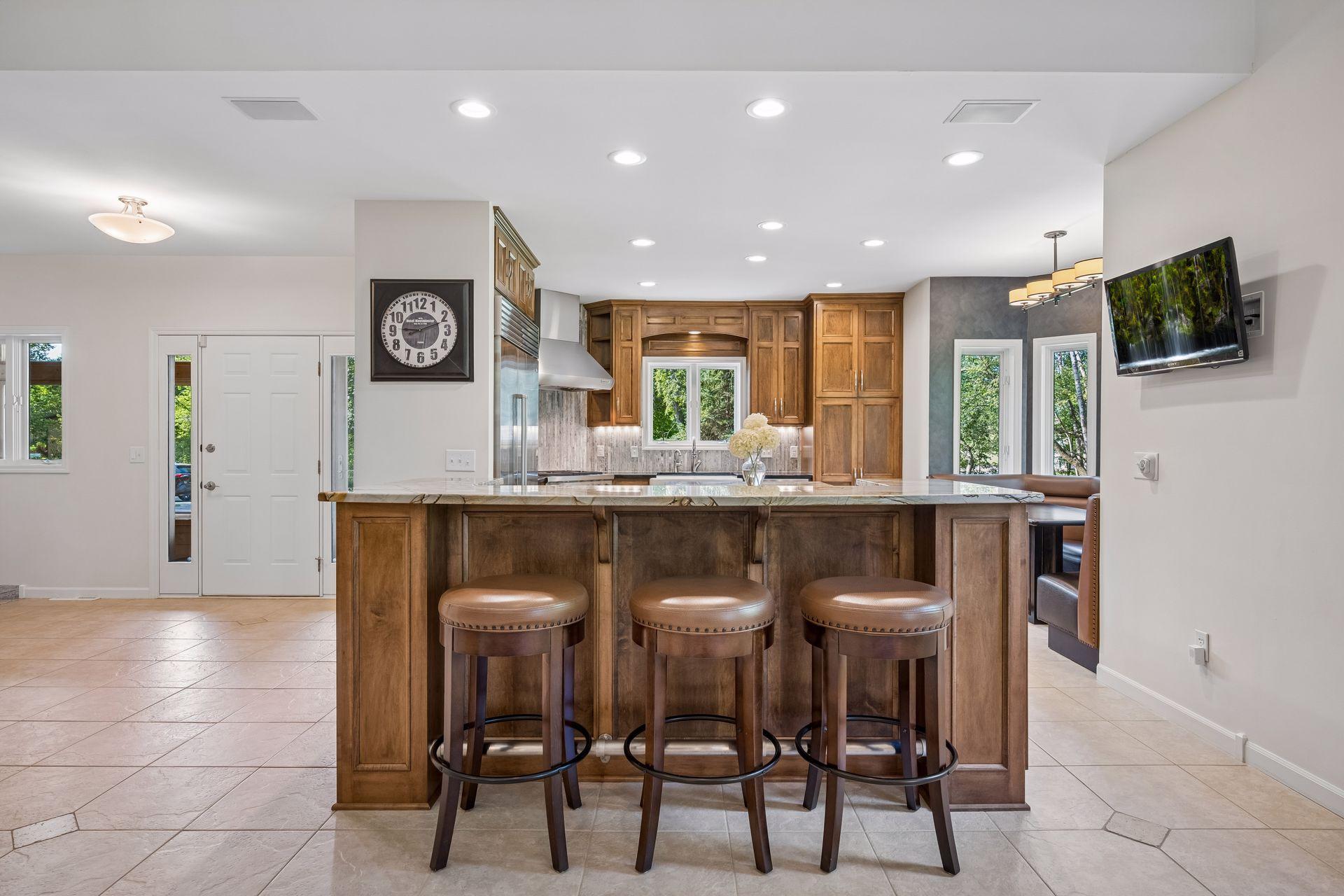 Bar seating at one of two custom built kitchen islands