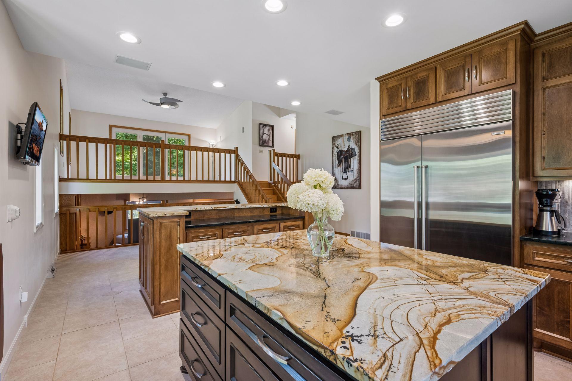 Kitchen opens to the dining area, and the vaulted living room above