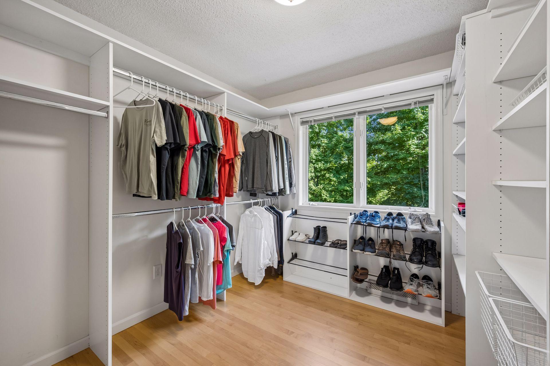 Bedroom 2 located on the upper level, currently utilized as a large walk-in closet