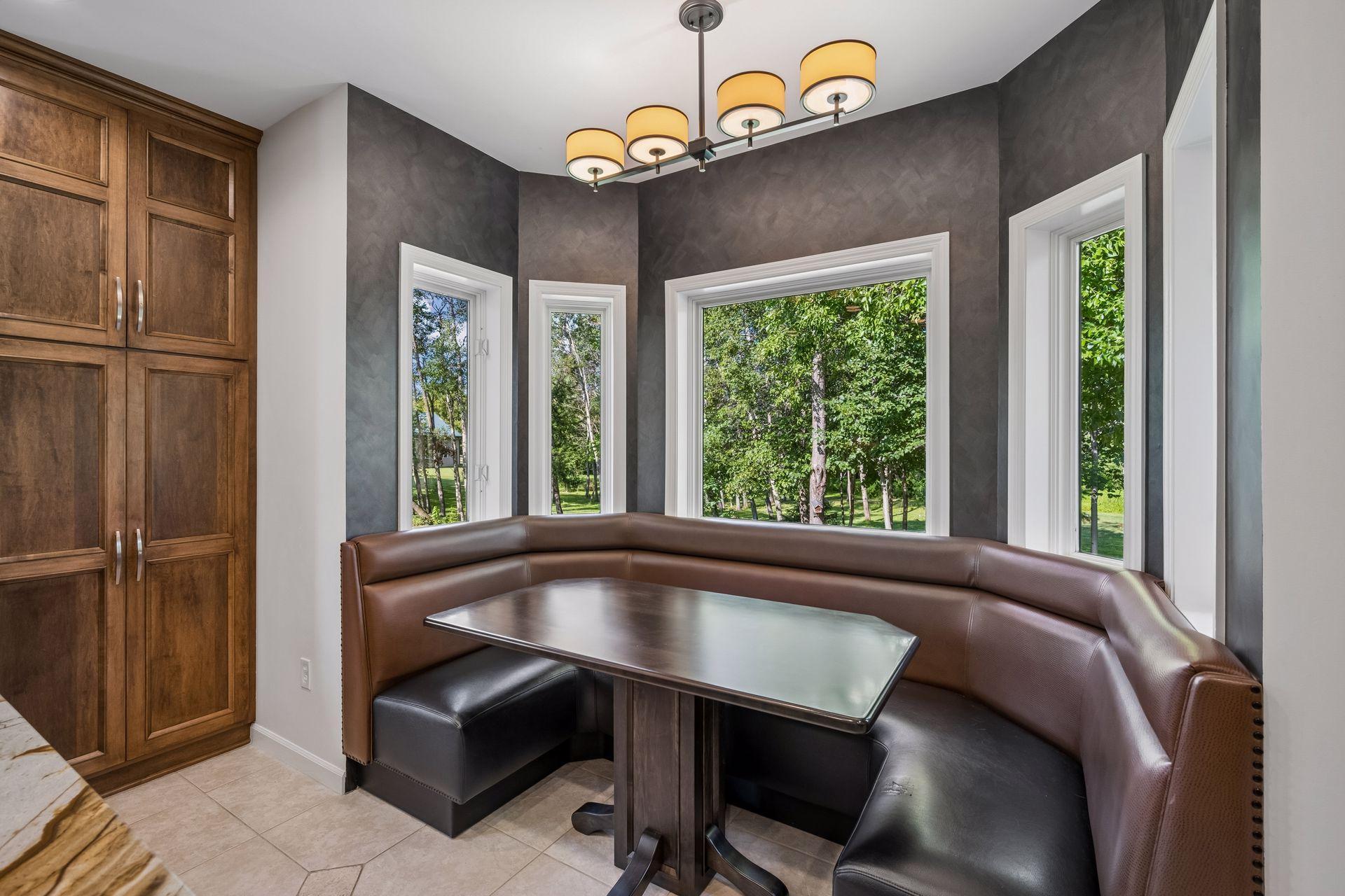 Banquette seating offers a comfortable area to be surrounded by nature, enjoy an intimate meal, and entertain guests