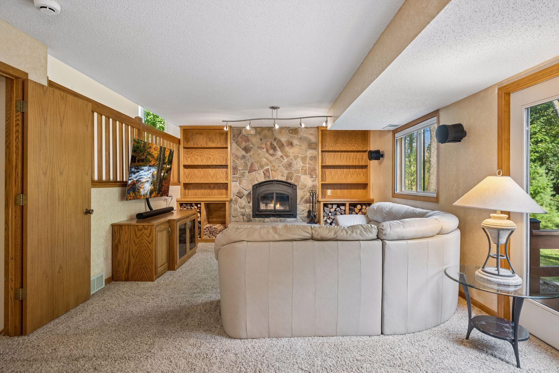 An impressive stone surround and efficient woodburning fireplace in the family room