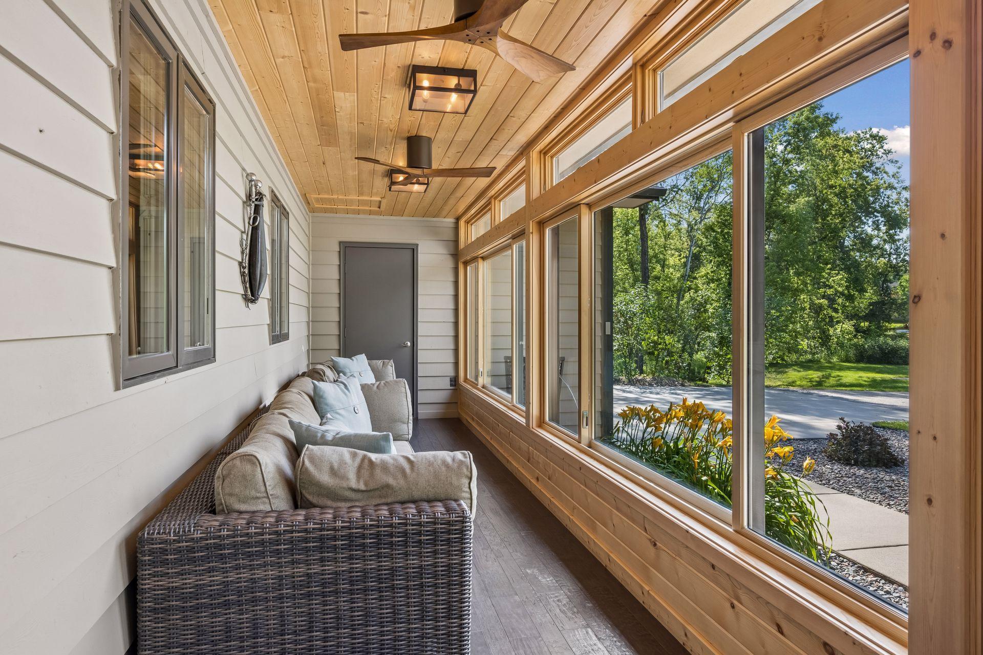The stunning enclosed front porch features high quality windows, and can be enjoyed all year long