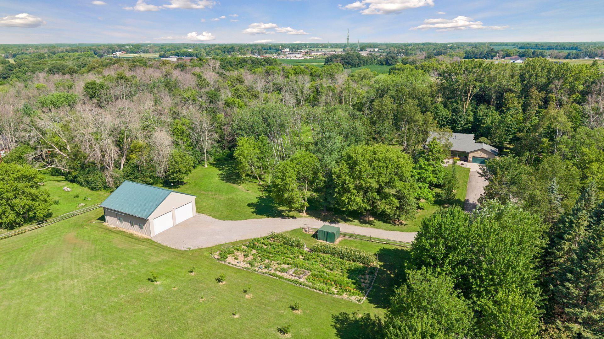 Wonderful 40' x 45' outbuilding set up for the recreational equipment, RV, or horse lover, plus open acres for gardens and pastures