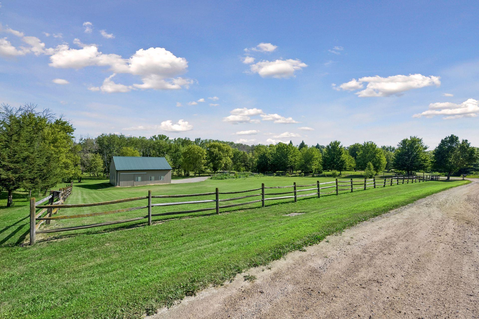 Open front pasture with hardy locust split-rail fencing, and easy access to the outbuilding
