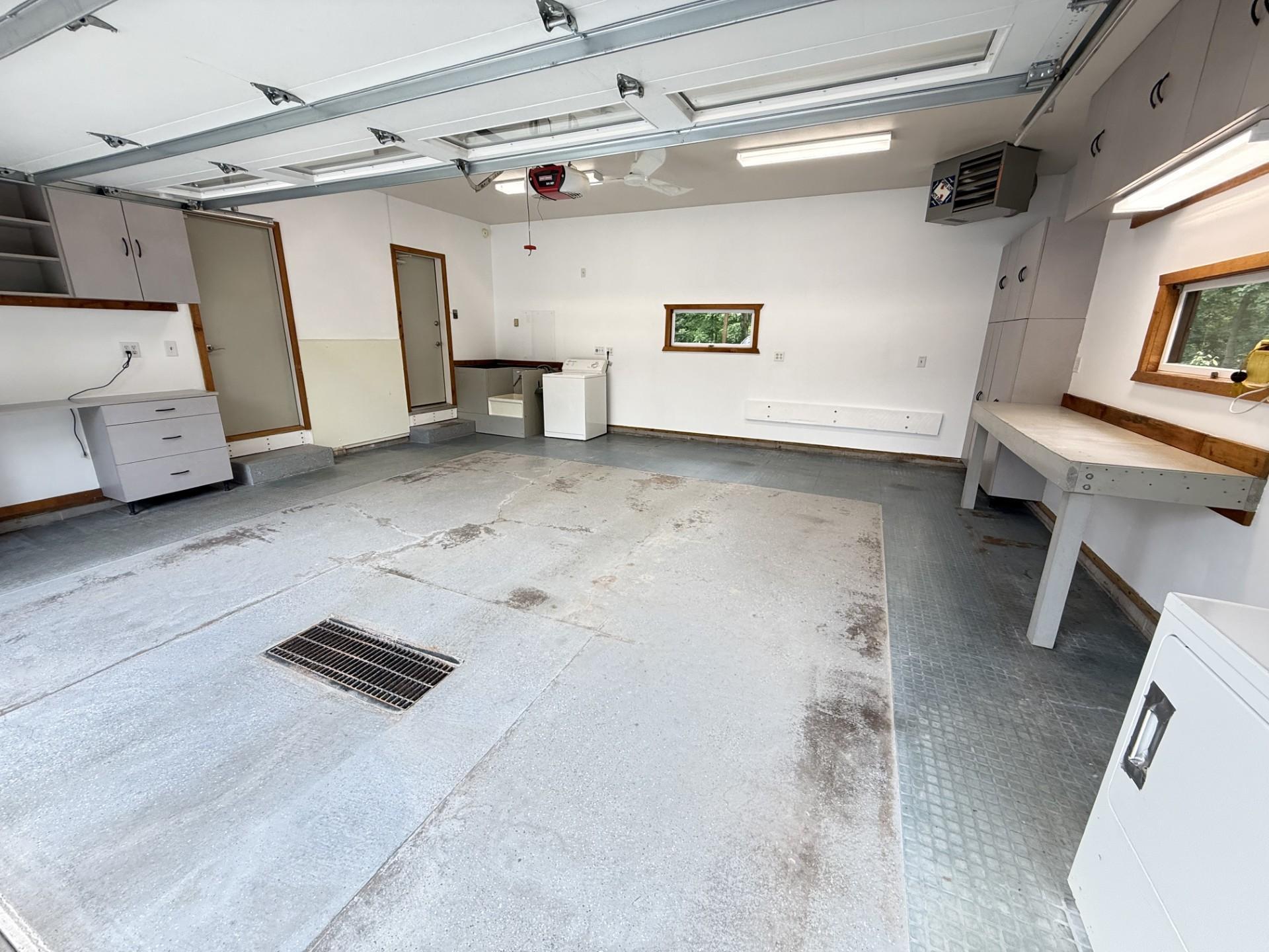 Attached garage is fully finished, heated and insulated, with a floor drain, and utility wash station. All cabinets and secondary washer and dryer will stay