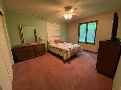 2nd bedroom has a large window looking out to the woods