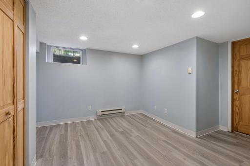 Additional lower-level flex space with updated flooring and recessed lighting.