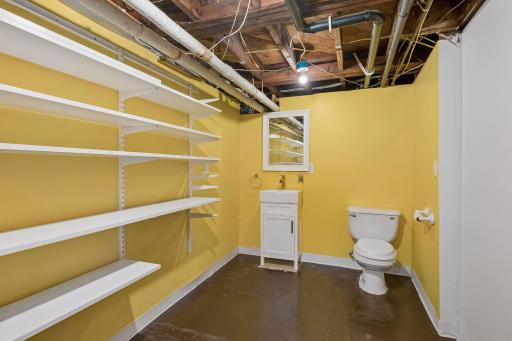 Convenient lower-level half bath with additional storage.
