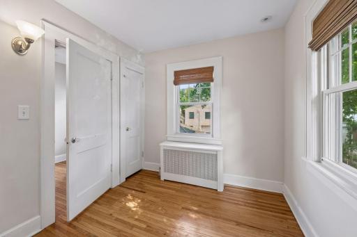 Upper-level bedroom with hardwood floors and classic 1920s character.
