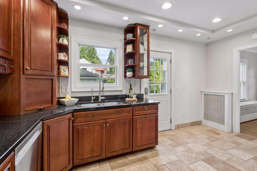 Updated kitchen with stone counters, stainless appliances and generous cabinetry.