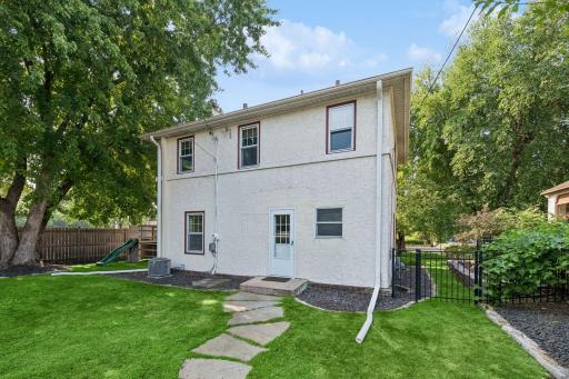 Rear exterior view showcasing the homeâs two-story design and generous yard.
