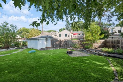 Spacious backyard framed by mature trees and established landscaping.
