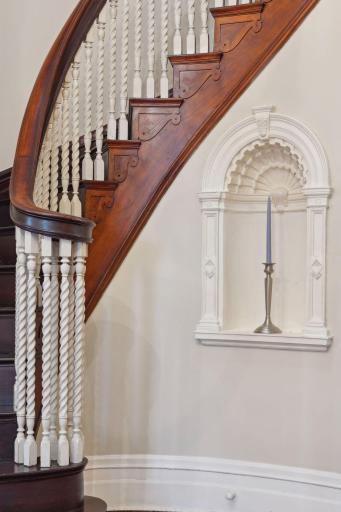 Sweeping hand-crafted staircase, a true architectural centerpiece