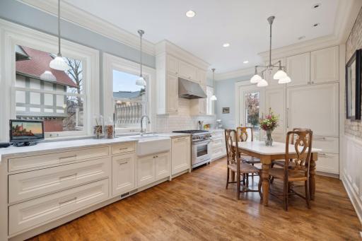 Fully renovated custom kitchen with farmhouse sink and island seating