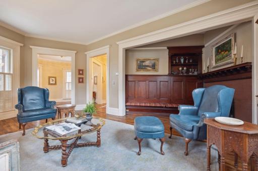 Living room flows seamlessly into a cozy fireplace sitting area