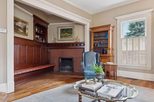 Rich wood paneling and a classic fireplace showcase the home's original craftsmanship