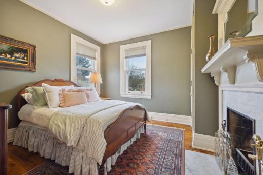Bedroom with a decorative fireplace, adding warmth and character