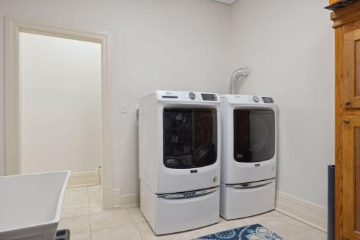 Convenient laundry room with full-size washer and dryer