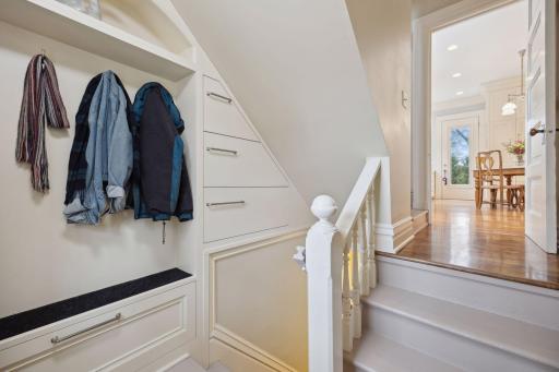 Functional mudroom with built-in storage near the stairwell