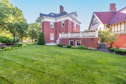 Sprawling backyard offers a private, park-like setting with a stately upper terrace