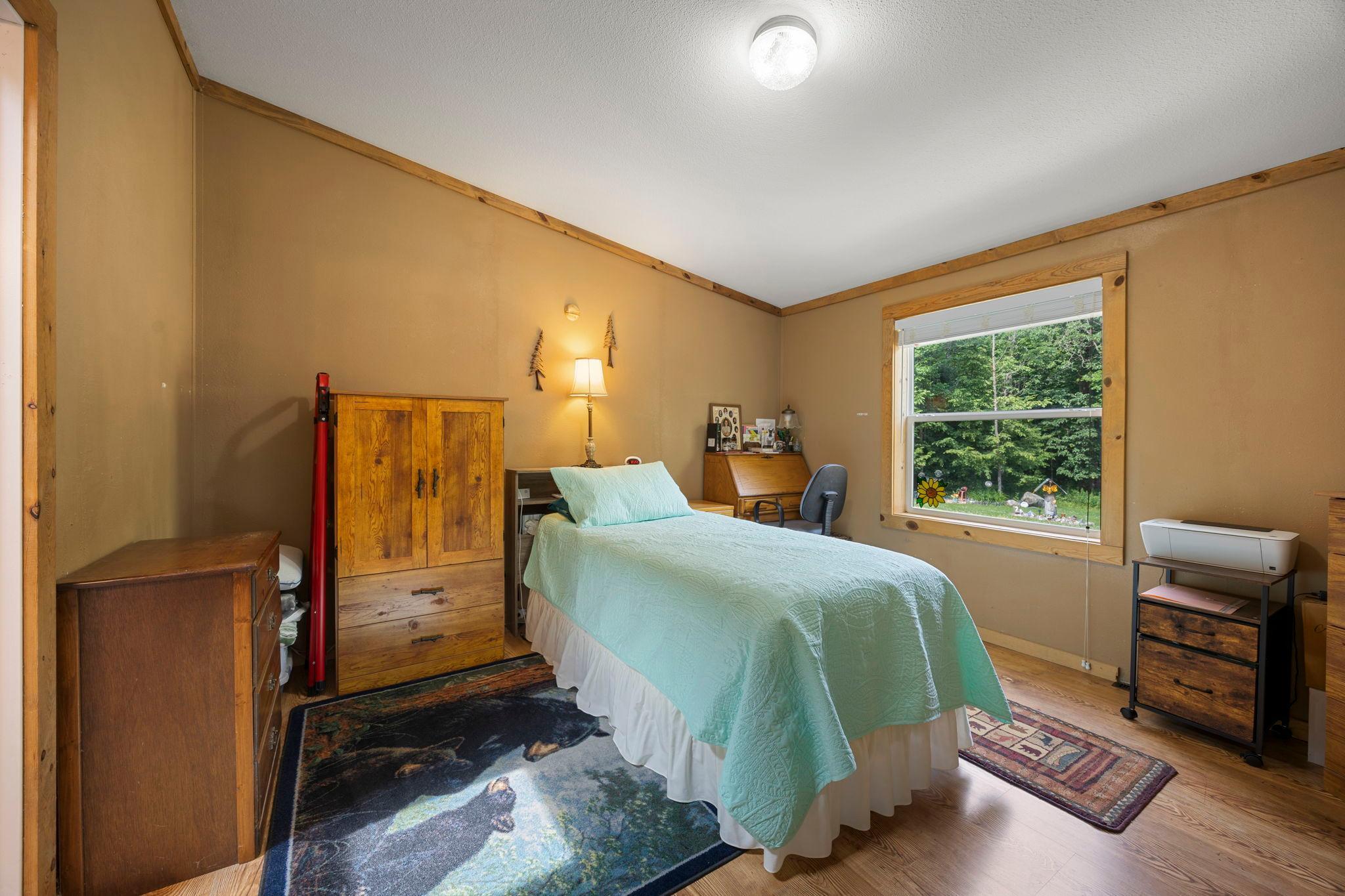 The primary bedroom includes a large window, walk-in closet and a private bath.