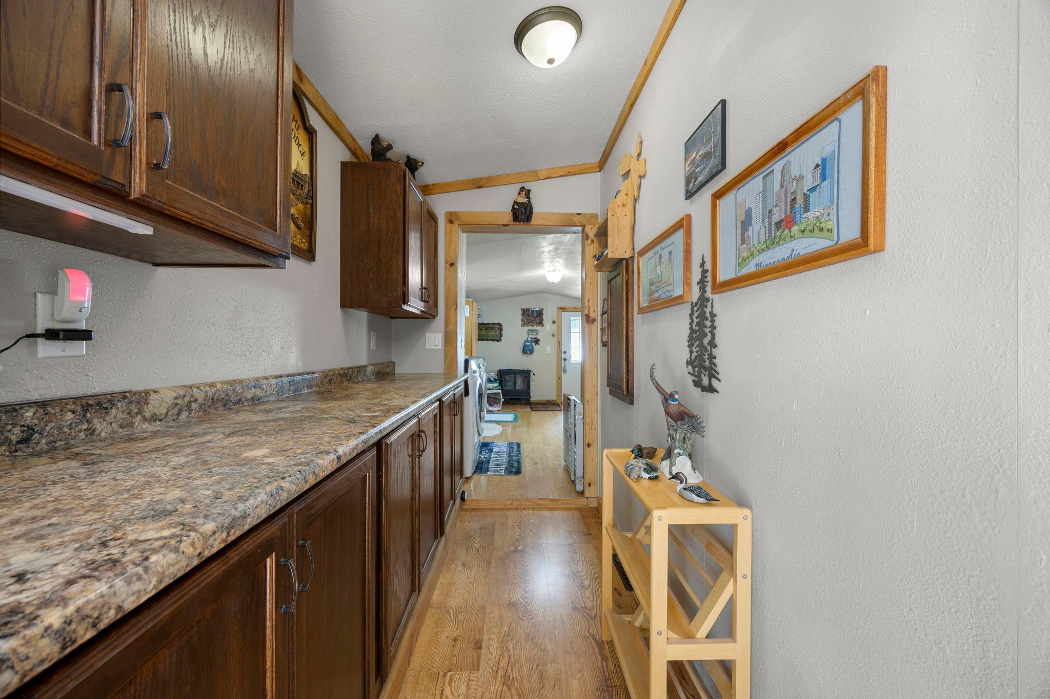 Awesome galley style pantry adds abundant cabinet & counter top space.