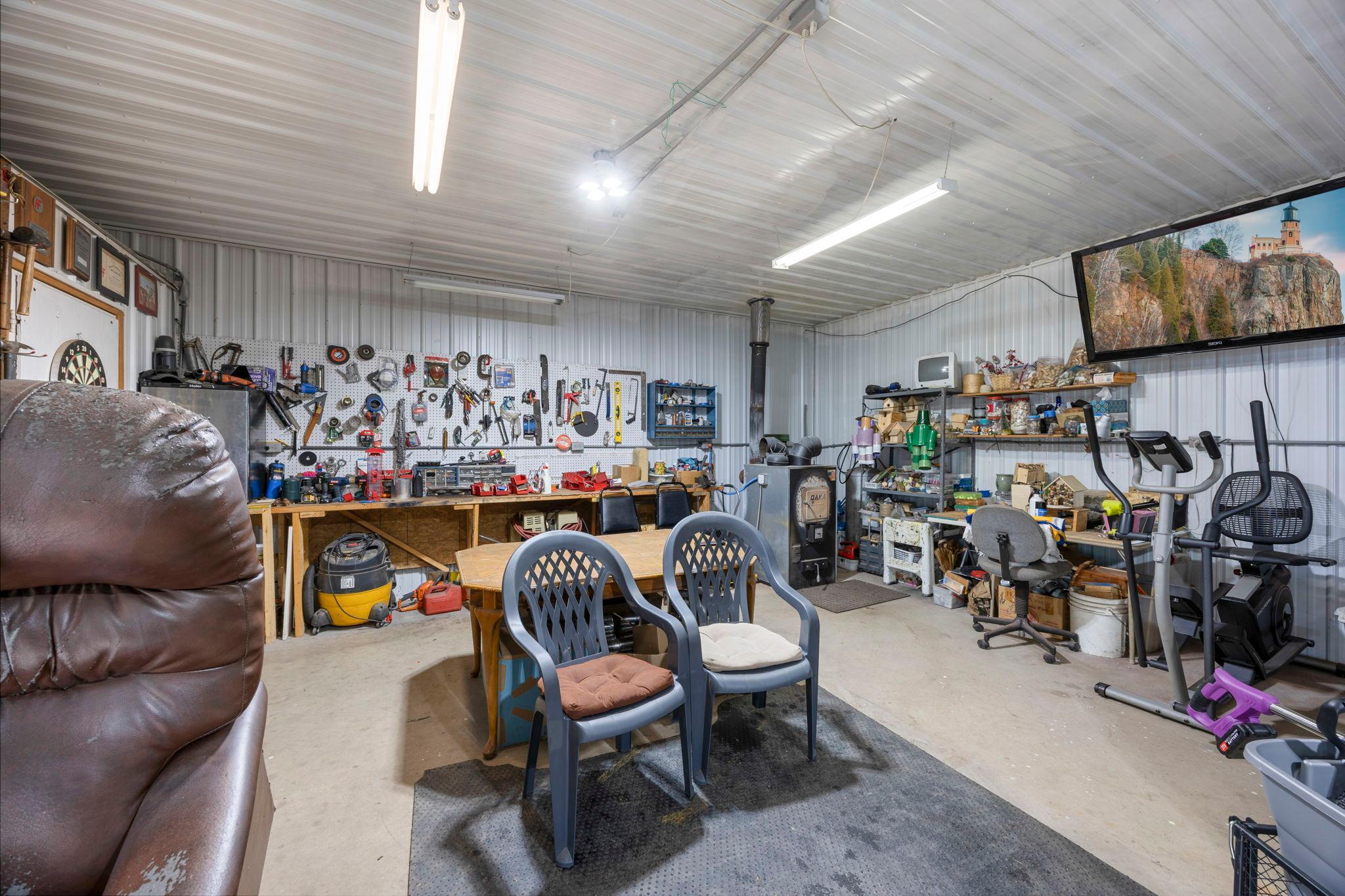 Includes a 60" TV to watch the big game & a woodstove to keep you toasty warm while working on projects.
