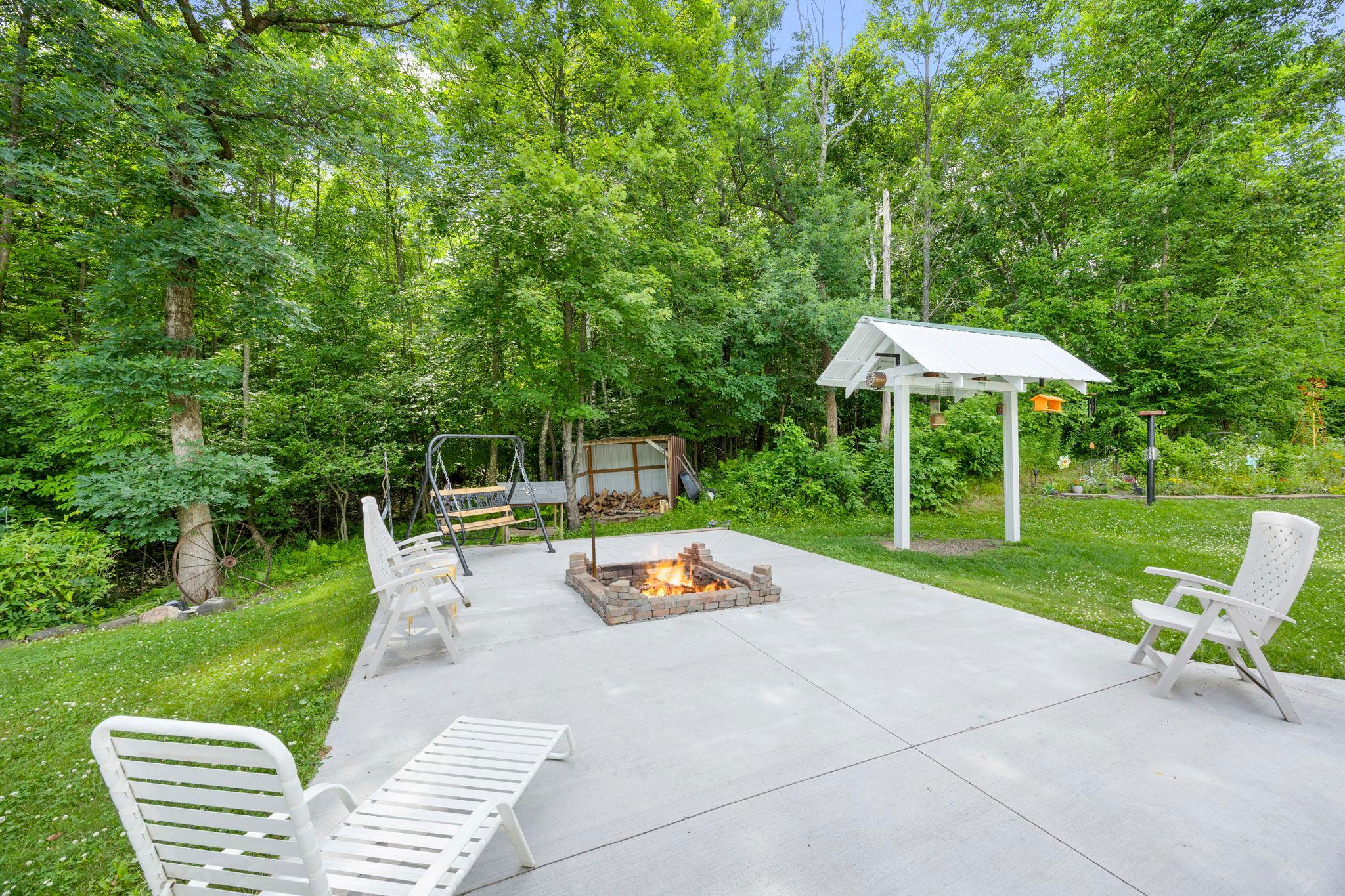 Complete with a birding station and handy woodshed to keep the firepit stocked.