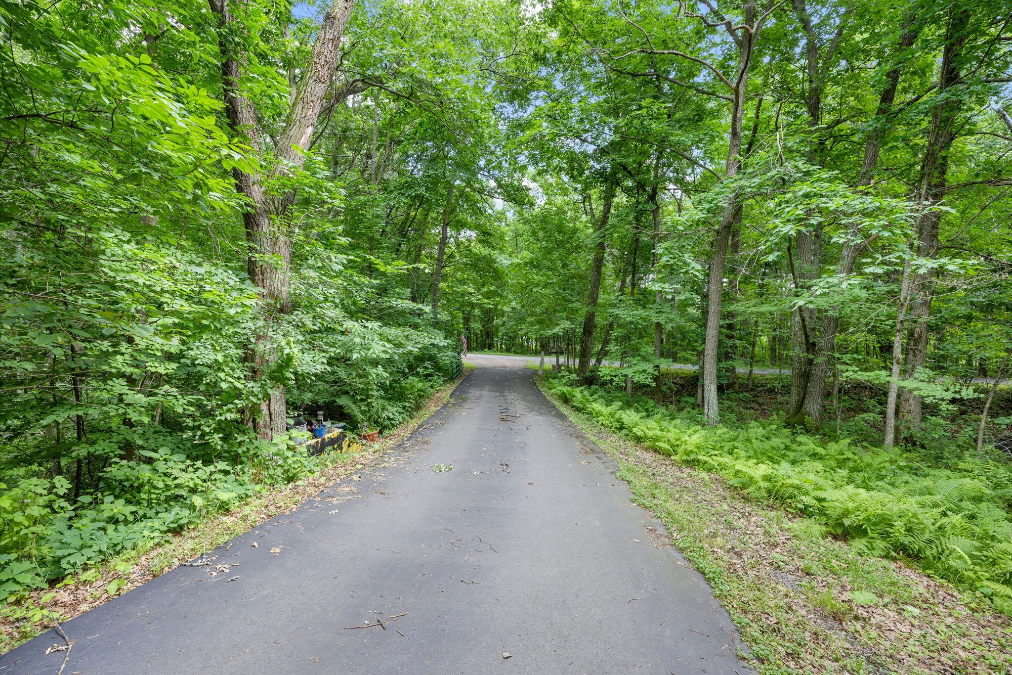The low maintenance blacktop driveway leads to your perfect private oasis.