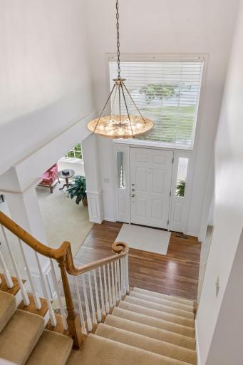Convenient dual staircase with access from the foyer and kitchen hallway.