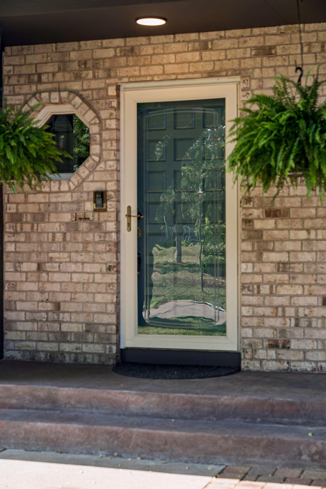 Sharp brick exterior with storm door and freshly painted front door. Welcome home!