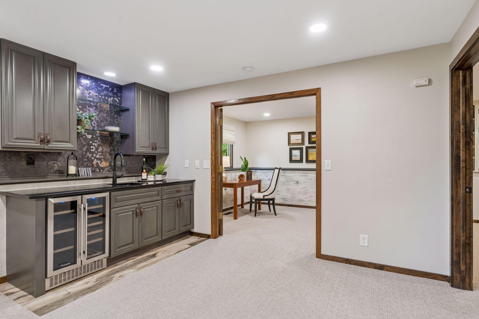Family room wet bar(2023). Cync lighting. Metallic penny-tile backsplash, bar/beverage fridge. Entertain with ease!