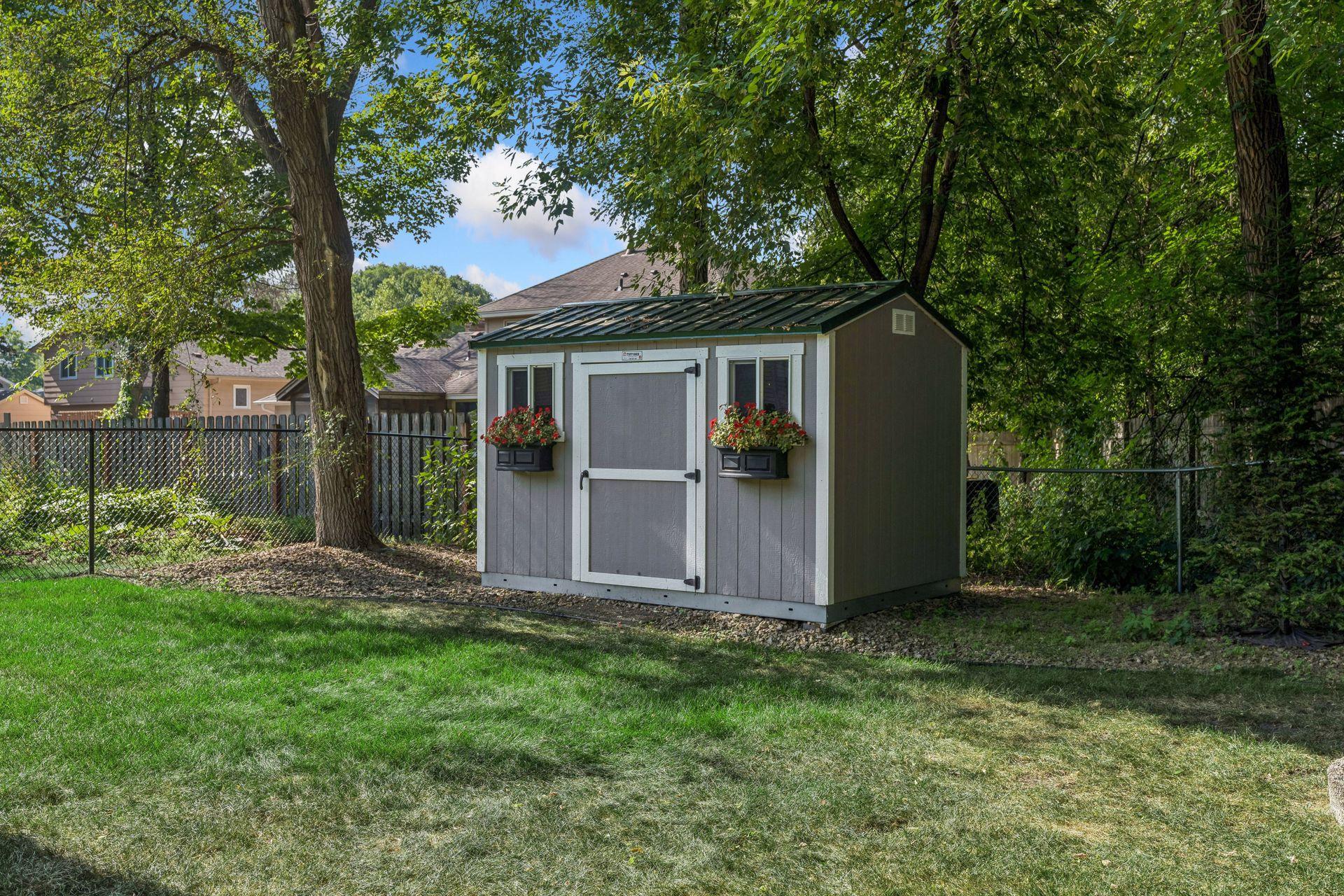Tuff Shed 8x12' with metal roof, integrated workbench and window boxes.
